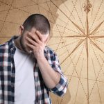 A man holding his face in distress