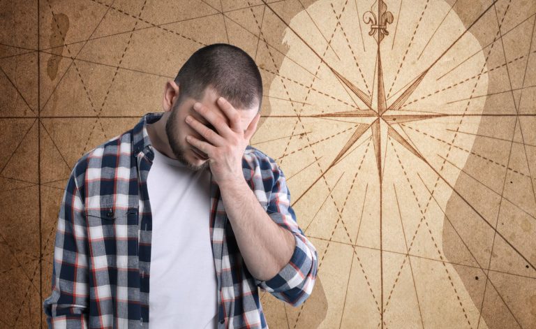 A man holding his face in distress