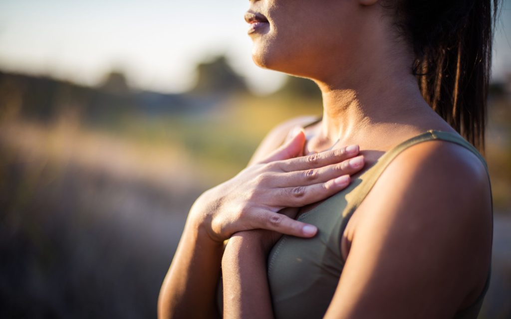 A photo of a woman concentrating on her breathing. Slow, deep breaths can help relieve stress. 