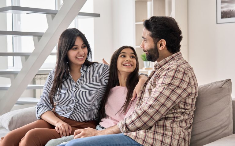 When Should I Talk to My Kids About Drugs and Alcohol? Parents on couch talking with their daughter.