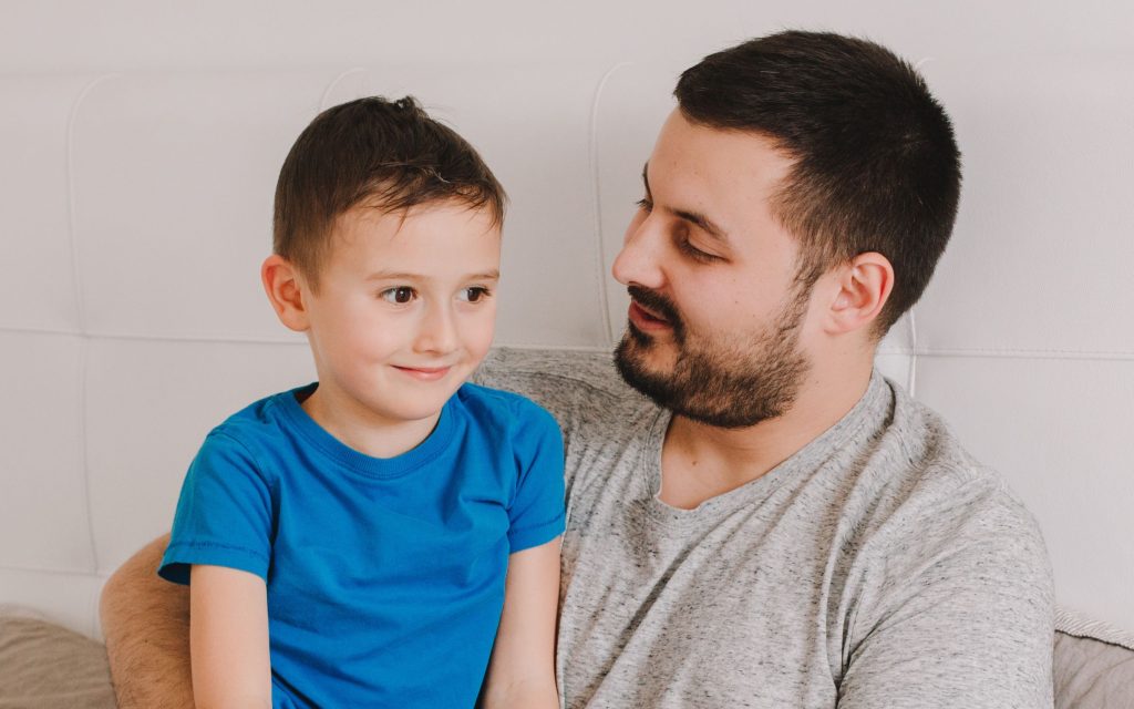 Father sitting with his preschool son. 